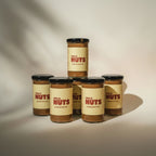 Jar of almond butter with a label reading 'This is Nuts' on a neutral background