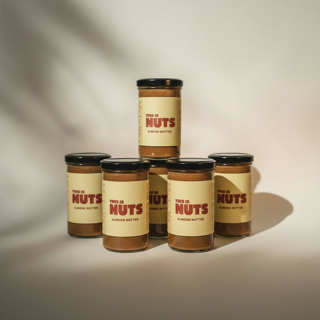 Jar of almond butter with a label reading 'This is Nuts' on a neutral background